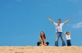 Happy three on sand dune top Royalty Free Stock Photo