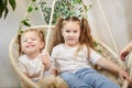 Happy time concept. Girls Sisters in chair and having fun. Female Preschooler and teenager playing relaxing in room