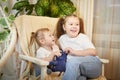 Happy time concept. Girls Sisters in chair and having fun. Female Preschooler and teenager playing relaxing in room