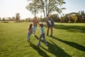 Happy time. Excited family running outdoors on a sunny day Royalty Free Stock Photo