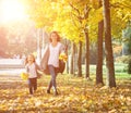 Happy time family and love abstract: mother and daughter run in autumn park