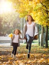 Happy time family and love abstract: mother and daughter run in autumn park