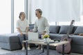 Happy time together. Mature man and woman sitting at window. Retired men and women singing in the living room