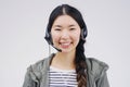 Happy to be of help. Studio portrait of an attractive young female customer service representative wearing a headset Royalty Free Stock Photo