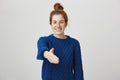 Happy to finally meet you. Studio shot of confident relaxed and friendly young woman with red hair combed in bun pulling