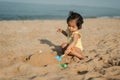 happy toddler baby girl playing sand toy on sea beach Royalty Free Stock Photo