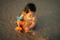 happy toddler baby girl playing toy and water on sea beach Royalty Free Stock Photo