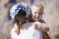 Happy toddler boy embracing mother