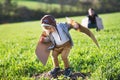 Happy toddler boy and father playing with wings outside in spring nature. Royalty Free Stock Photo