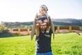 Happy toddler boy and father playing with wings outside in spring nature. Royalty Free Stock Photo