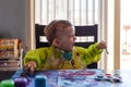 Toddler boy painting at the kitchen table Royalty Free Stock Photo