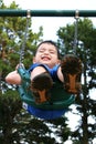 Happy Toddler Boy Laughing On Swing Royalty Free Stock Photo