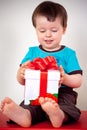 Happy toddler boy opening a gift box Royalty Free Stock Photo