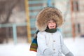 Happy toddler boy in winter jacket with fur trim Royalty Free Stock Photo