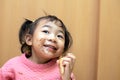 A happy toddler child eating chocolate ice cream in a cone with a messy face Royalty Free Stock Photo