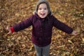 Happy toddler child plays with yellow leaves on sunny autumn day Royalty Free Stock Photo