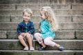 Happy toddler children sit on the steps