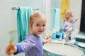 Happy toddler girl in pyjamas brushing her teeth in bathroom Royalty Free Stock Photo
