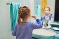 Happy toddler girl in pyjamas brushing her teeth in bathroom Royalty Free Stock Photo