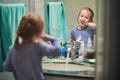 Happy toddler girl in pyjamas brushing her teeth in bathroom Royalty Free Stock Photo