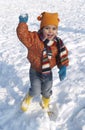 Happy toddler girl is throwing snow balls Royalty Free Stock Photo