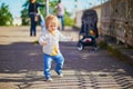 Happy toddler girl walking in the street of Helsinki, Finland Royalty Free Stock Photo