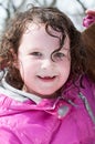 Happy toddler girl in warm coat on on snow day and having a fun in the winter outside, outdoor portrait Royalty Free Stock Photo