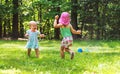 Happy toddler girls playing in a sprinkler Royalty Free Stock Photo