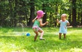 Happy toddler girls playing in a sprinkler Royalty Free Stock Photo