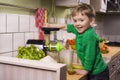 Happy toddler making green juice
