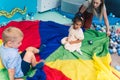 Happy toddlers having an active sensory play at the nursery school. Kids wellness. Early fine motor and gross motor