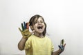Happy toothless little girl with painted hands laughing and having fun - Little girl who is painting her hands with smiley faces Royalty Free Stock Photo