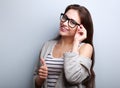 Happy toothy smiling young woman in glasses showing thumb up