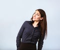 Happy toothy thinking smiling business woman looking up in blue shirt on blue background with empty copy space. Closeup Royalty Free Stock Photo