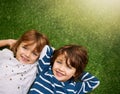 Happy, top view and portrait of kids on grass for relaxing, bonding and happiness in garden. Family, nature and above of Royalty Free Stock Photo