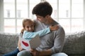 Happy touched young dad cuddling little daughter. Royalty Free Stock Photo