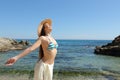 Happy tourist breathing deep fresh air on beach vacation