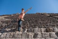 Happy tourist climbing Pyramid of the Sun in Teotihuacan, Mexi