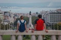 Happy tourist couple sitting at Miradouro Park Eduardo VII in Lisbon, Portugal, Europe, looking towards gardens in the park with