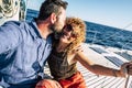 Happy tourist couple of traveler people in love enjoying the sail boat trip together having fun and smiling - cheerful adult man