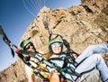 Happy tourist doing paragliding sport activity in outdoor leisure active lifestyle. Cheerful adult woman doing selfie picture Royalty Free Stock Photo