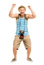 Happy tourist holding retro camera isolated on white