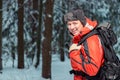 happy tourist in a jacket on a hike with a backpack