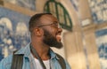 Happy tourist man against azulejo Royalty Free Stock Photo