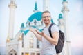 Happy tourist man with backpack smiling on background of Kul Sharif Mosque Kazan Kremlin. Concept Travel Russia Royalty Free Stock Photo