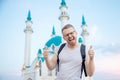 Happy tourist man with backpack smiling on background of Kul Sharif Mosque Kazan Kremlin. Concept Travel Russia Royalty Free Stock Photo