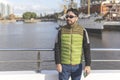 Happy tourist posing in front of a boat in Puerto Madero