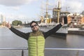 Happy tourist posing in front of a boat in Puerto Madero