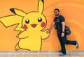 Happy tourist posing with a Pokemon Pikachu figure at Pokemon Center store in Sunshine City shopping mall Royalty Free Stock Photo