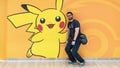 Happy tourist posing with a Pokemon Pikachu figure at Pokemon Center store in Sunshine City shopping mall Royalty Free Stock Photo